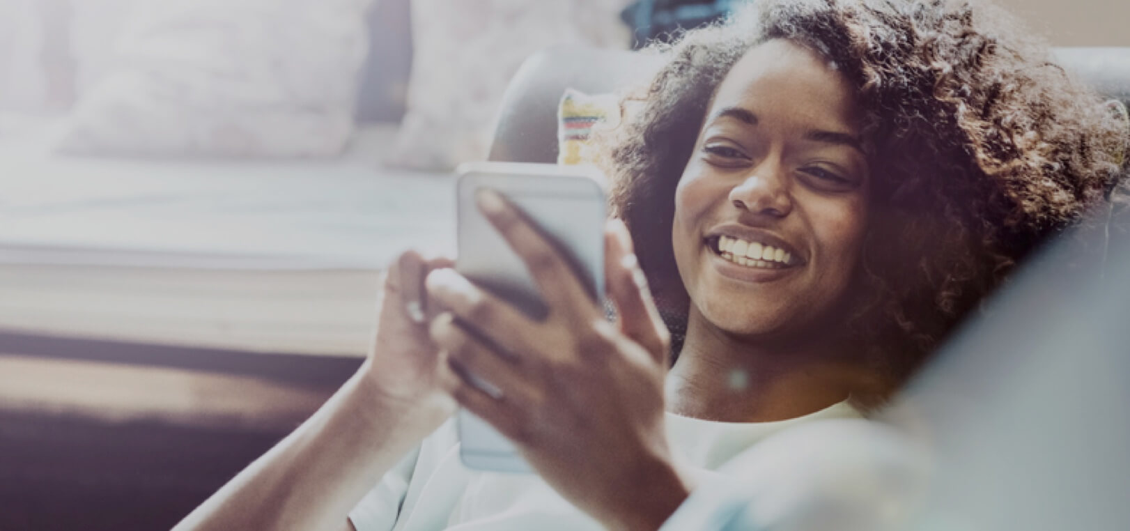 Happy Woman browsing websites on her mobile device